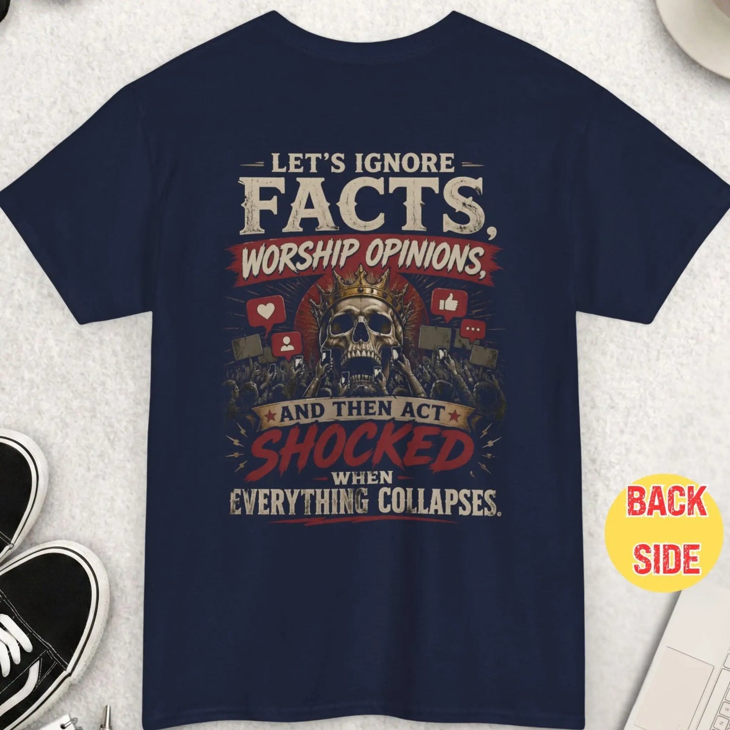 Navy blue t-shirt showing skull with crown and crowd holding phones with bold text about ignoring facts and societal collapse