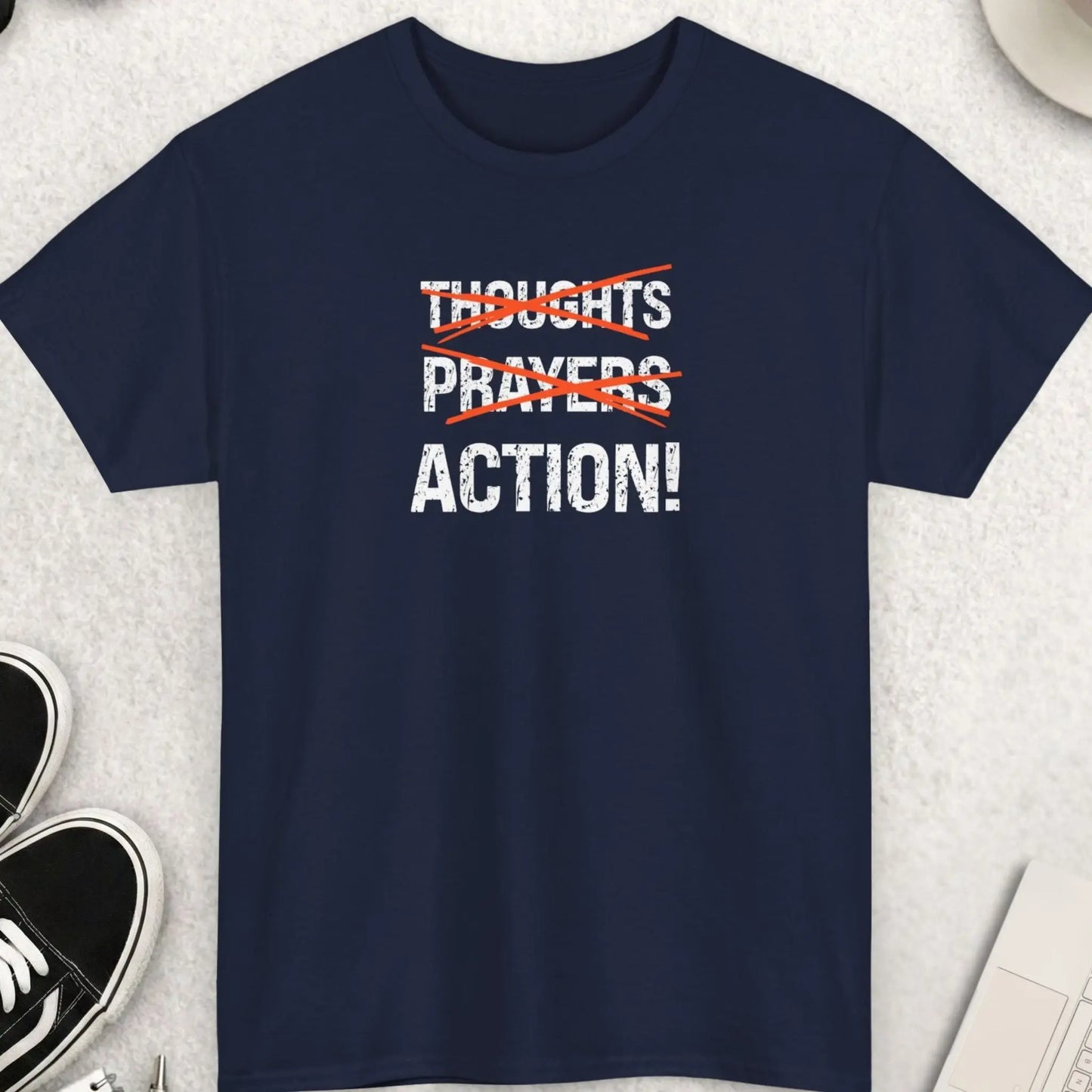 Navy blue t-shirt with distressed “Thoughts Prayers Action” statement graphic and red strike-through design