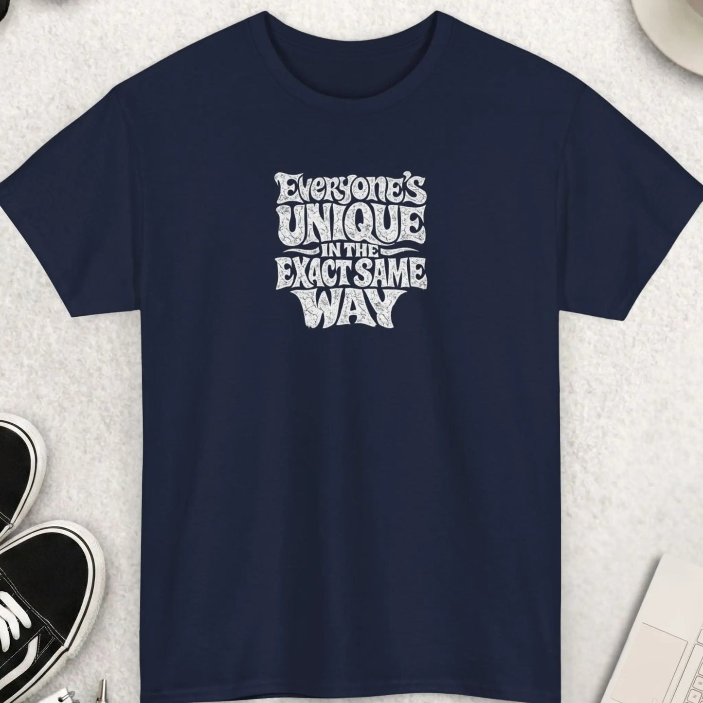 Navy blue sarcastic graphic tee featuring distressed white distorted typography reading “Everyone’s Unique In The Exact Same Way” in a bold vintage grunge style.