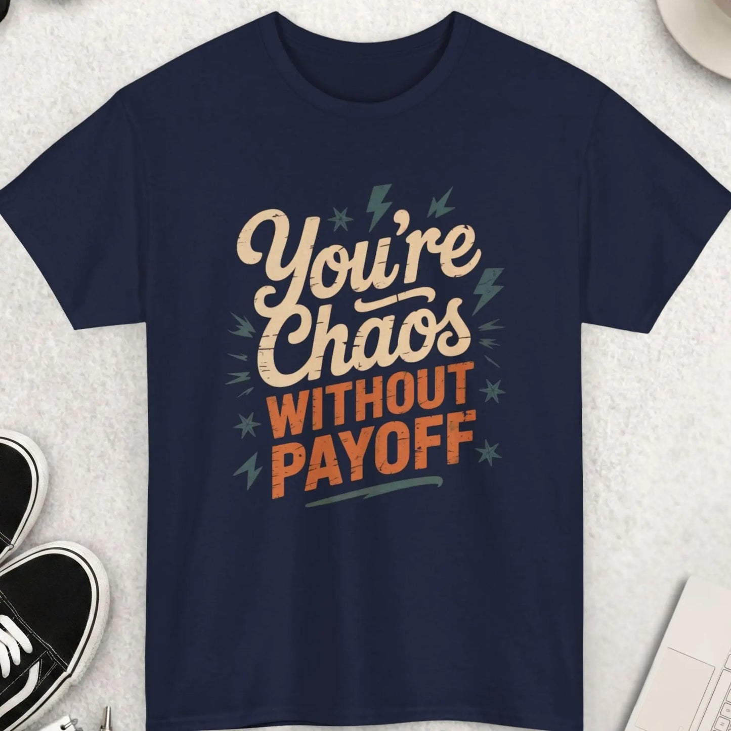 Navy blue t-shirt with motivational quote on a light gray surface with accessories.