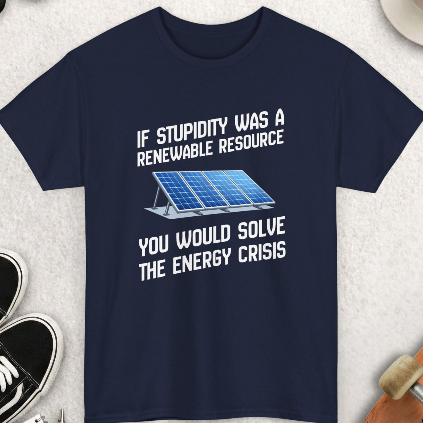 Navy blue t-shirt with humorous text and solar panel graphic on a light gray surface with accessories.
