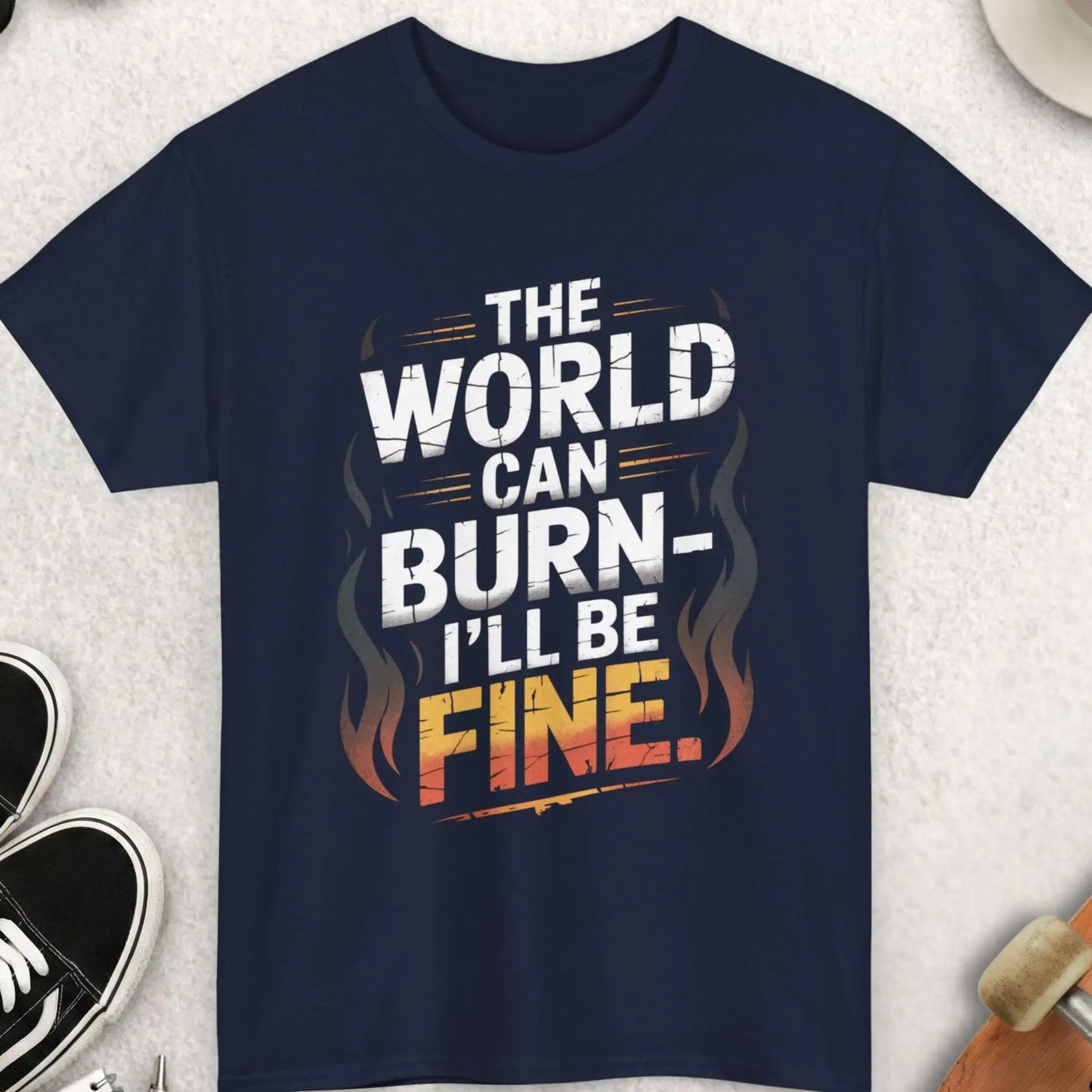 Navy blue t-shirt with humorous text design on a light gray surface with accessories.