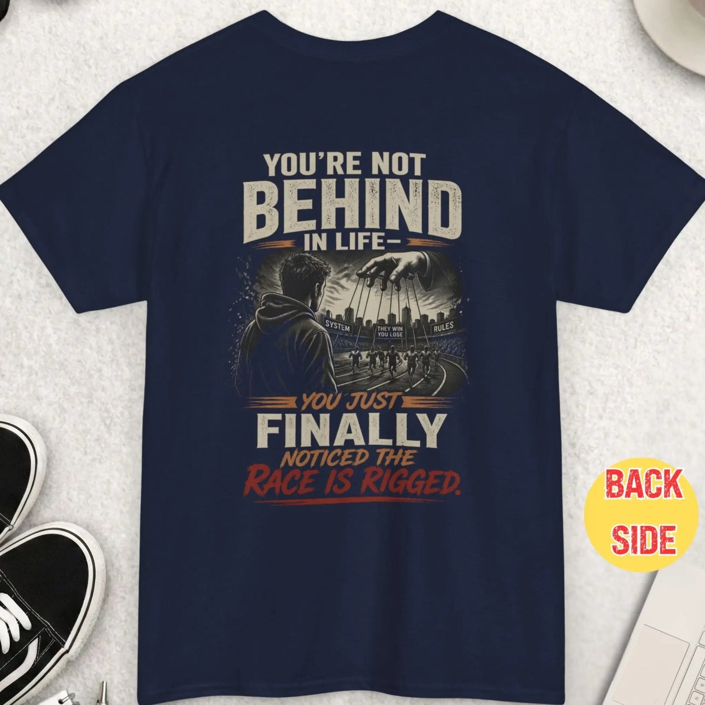 Navy blue t-shirt showing symbolic rigged system design with puppet controlled runners and bold awareness text about life and control system