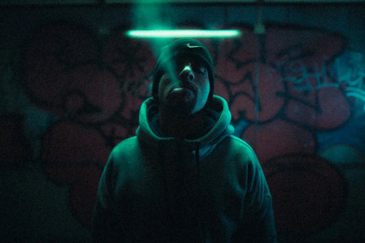 a man standing in a dark room with graffiti on the walls