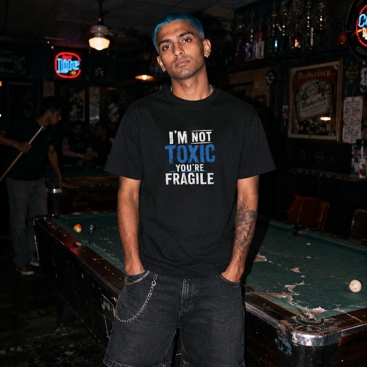 Mayhem Haus I’m Not Toxic, You’re Fragile T-Shirt on a person with blue hair in a pool hall