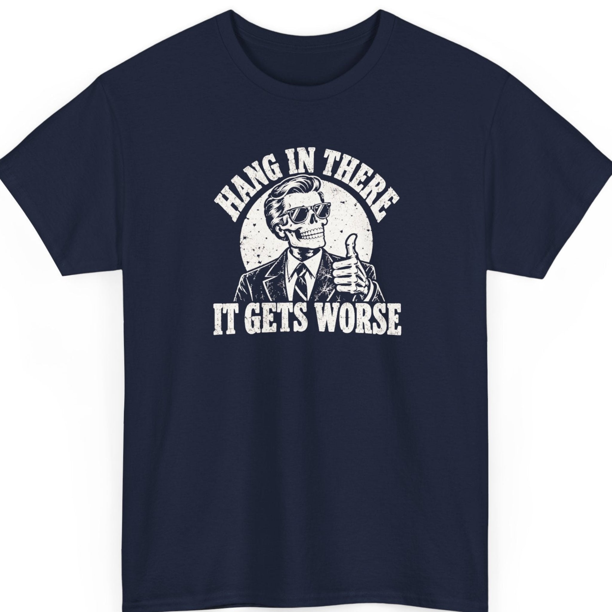 Mayhem Haus “Hang in There It Gets Worse” navy blue t-shirt featuring a slick-haired skeleton wearing sunglasses, a suit, and a tie while giving a thumbs-up, surrounded by distressed white lettering and vintage grunge textures.