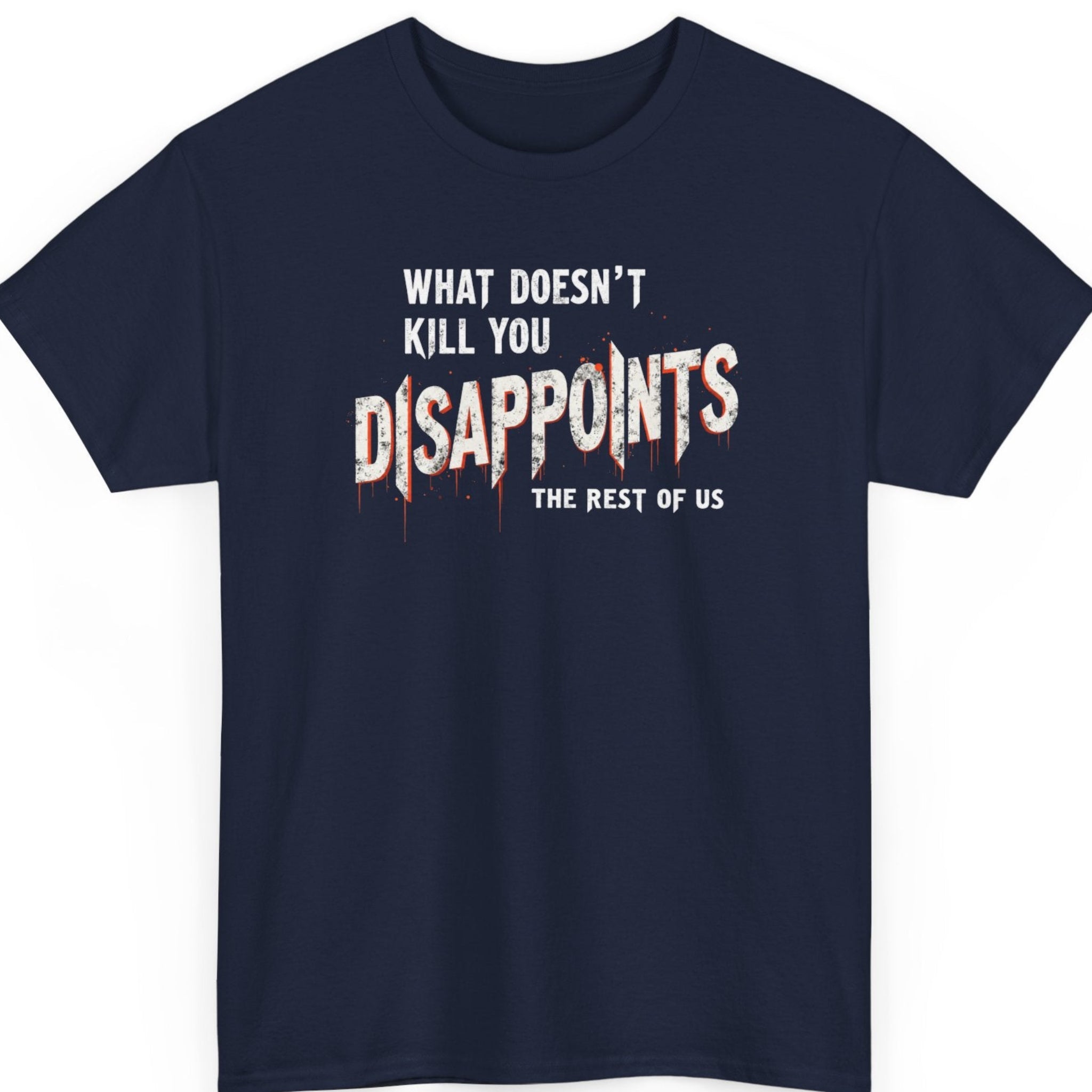 Mayhem Haus dark humor graphic tee on a navy blue shirt featuring bold distressed typography with the sarcastic quote "What Doesn't Kill You Disappoints The Rest Of Us," highlighted by oversized white lettering and subtle red drip effects.