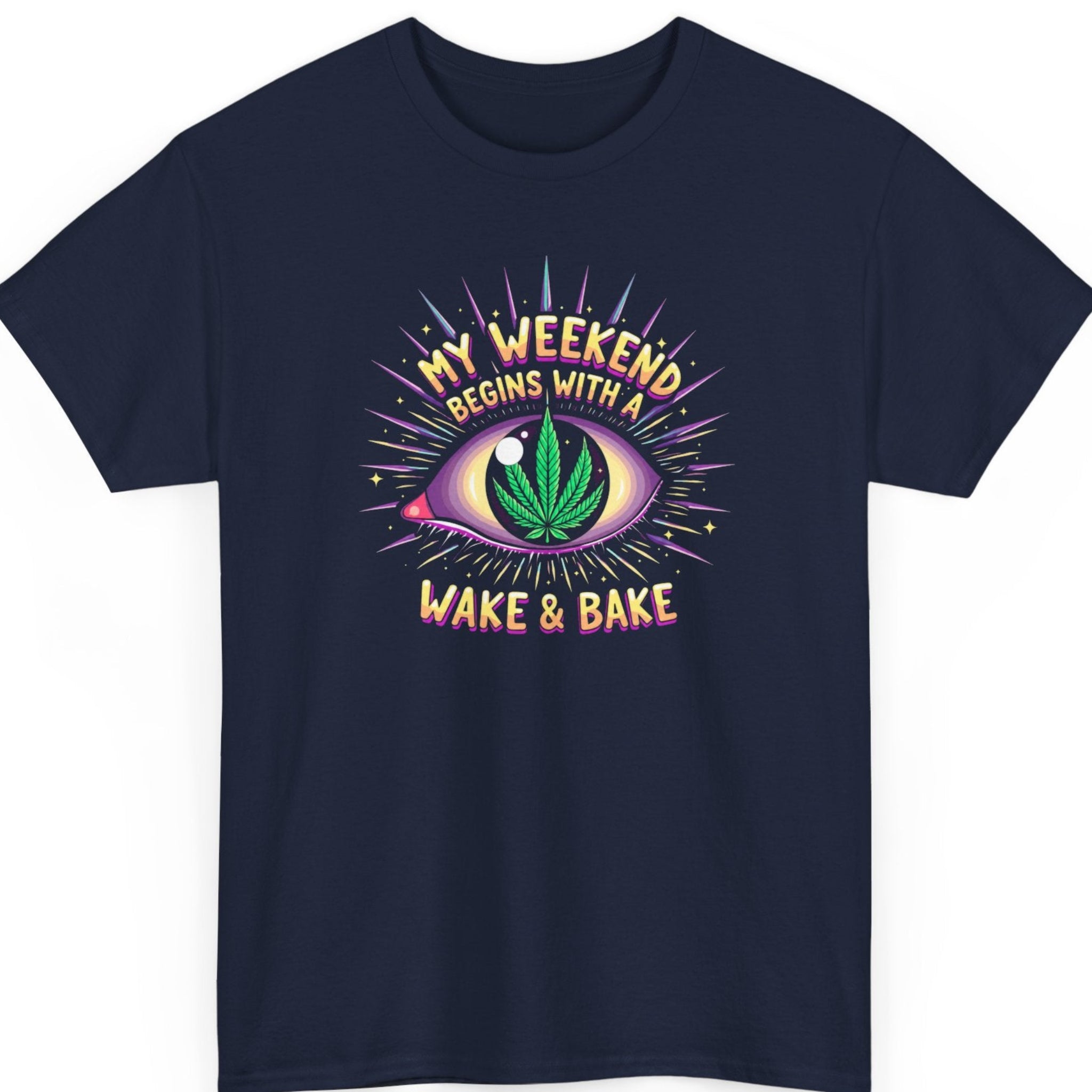Mayhem Haus wake and bake t-shirt on a navy blue tee featuring a vibrant all-seeing eye with a cannabis leaf pupil and bold retro lettering reading "My Weekend Begins With A Wake & Bake."