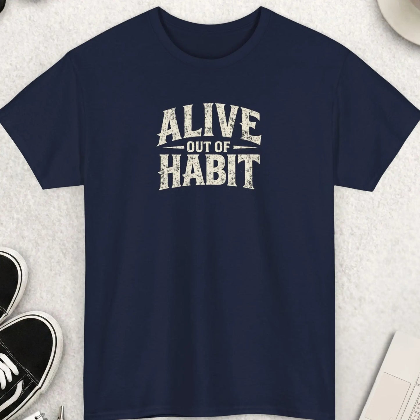 Navy blue graphic tee with distressed cream typography reading “Alive Out Of Habit” in a bold minimalist grunge streetwear style by Mayhem Haus.