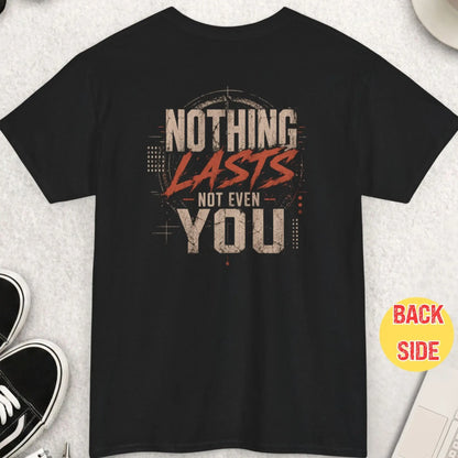 Black t-shirt featuring distressed grunge typography reading “Nothing Lasts Not Even You” with bold scratched red lettering and layered industrial graphic elements.