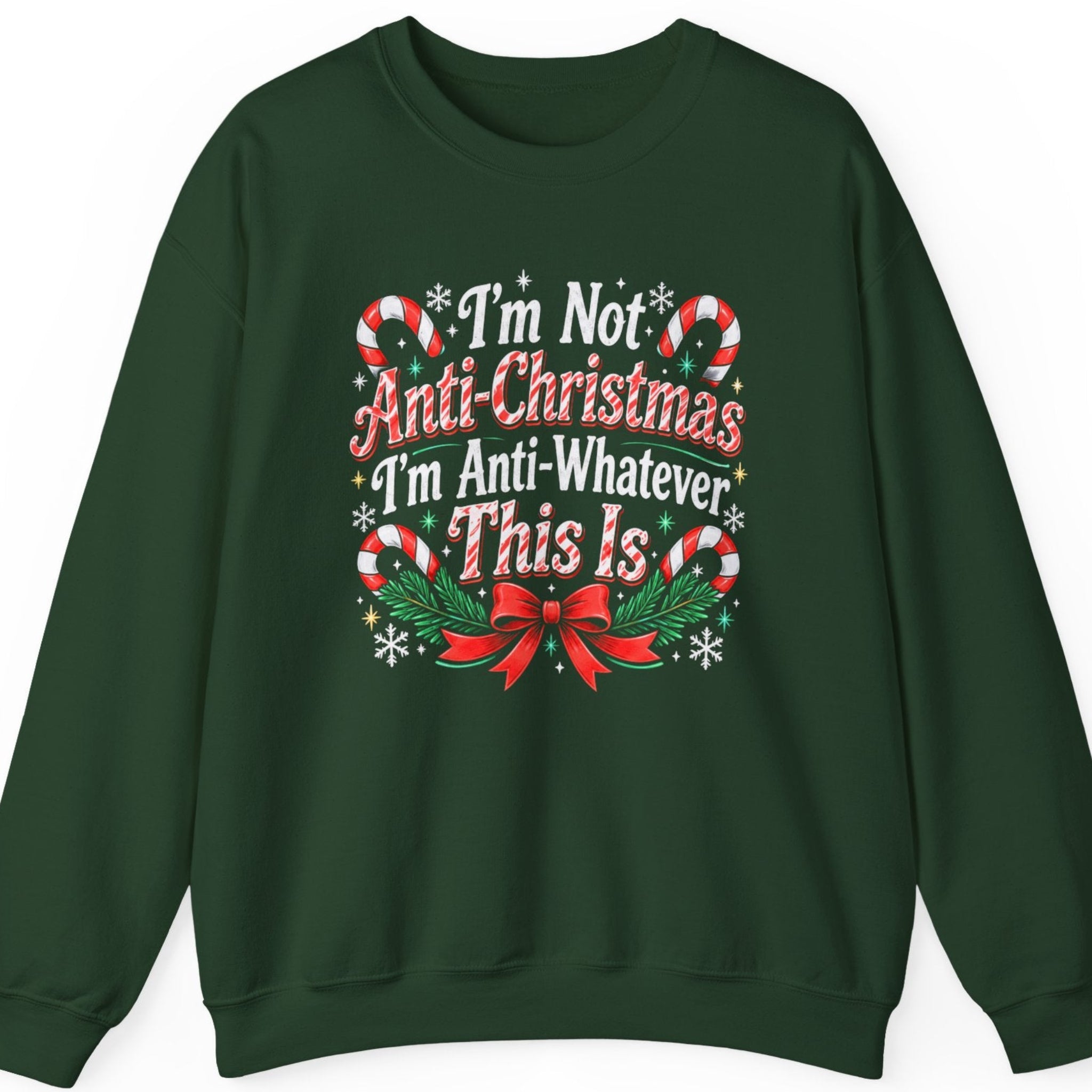 Mayhem Haus “I'm Not Anti-Christmas I'm Anti-Whatever This Is” forest green crewneck sweatshirt featuring distressed red and white vintage Christmas typography, surrounded by four red-and-white striped candy canes, green holly leaves, white snowflakes, golden stars, evergreen branches, and a decorative red ribbon bow.