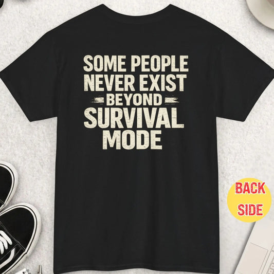 Black t-shirt featuring distressed bold typography reading “Some People Never Exist Beyond Survival Mode” in a minimalist high-contrast design.