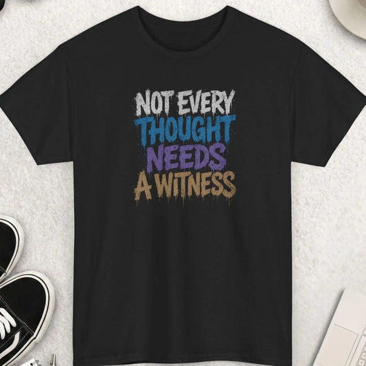 Black distressed graphic t-shirt featuring the phrase “Not Every Thought Needs A Witness” in dripping white, blue, purple, and tan grunge typography with a dark humor streetwear aesthetic by Mayhem Haus.