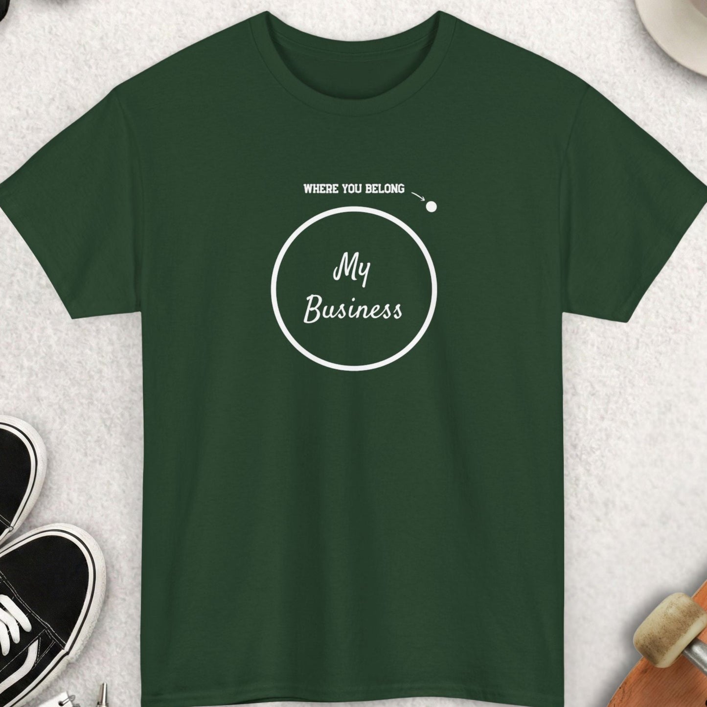 Green t-shirt with 'My Business' design on a light gray surface with accessories.