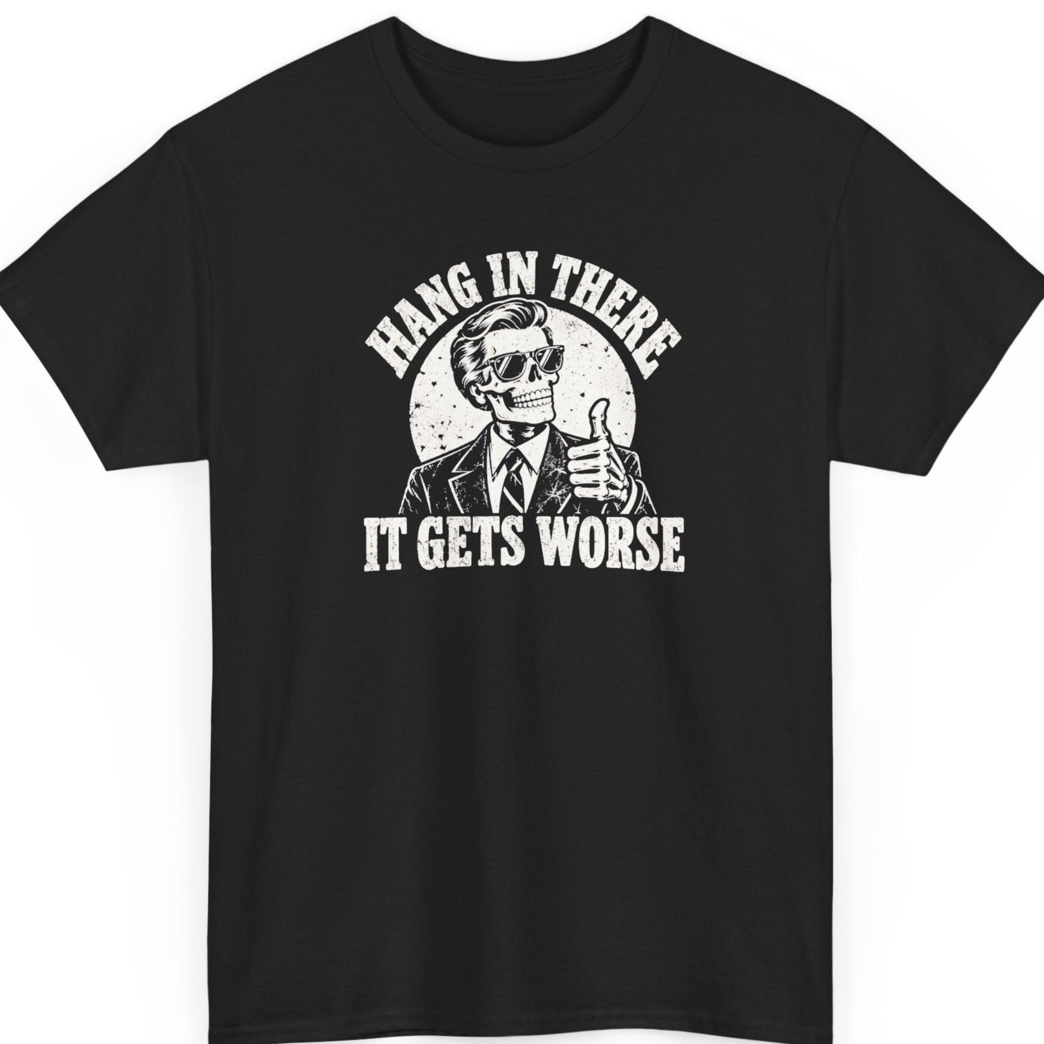 Mayhem Haus “Hang in There It Gets Worse” black t-shirt featuring a distressed black-and-white illustration of a smiling skeleton in a business suit and sunglasses giving a thumbs-up, framed by bold weathered typography.