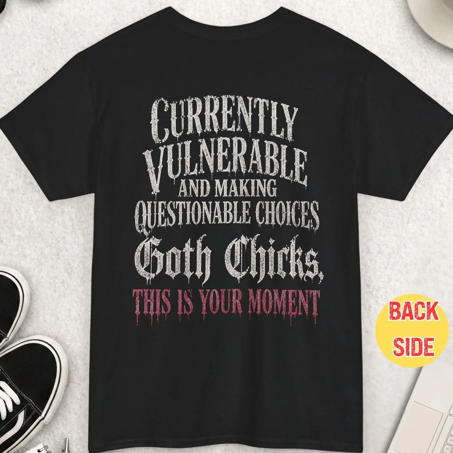 Black t-shirt featuring distressed gothic dripping typography reading “Currently Vulnerable and Making Questionable Choices Goth Chicks This Is Your Moment” in a bold alt-style design.