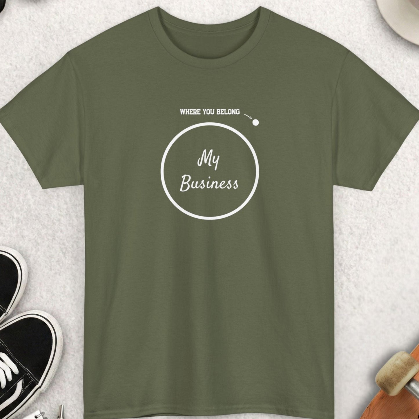 Green t-shirt with 'My Business' design on a light gray surface with accessories.