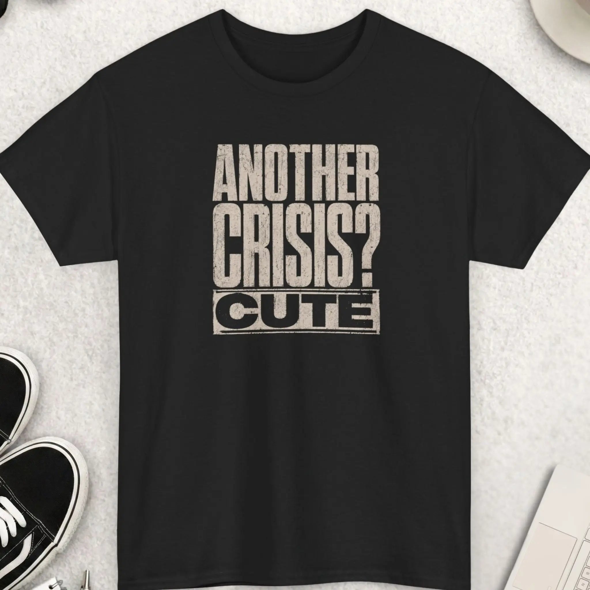 Distressed typography t-shirt design reading “Another Crisis? Cute.” in oversized vintage cream lettering on a black shirt with bold sarcastic dark humor aesthetic.