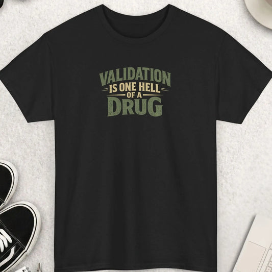 Black t-shirt featuring distressed vintage typography reading “Validation Is One Hell Of A Drug” in muted earth-tone colors with a bold minimalist layout.