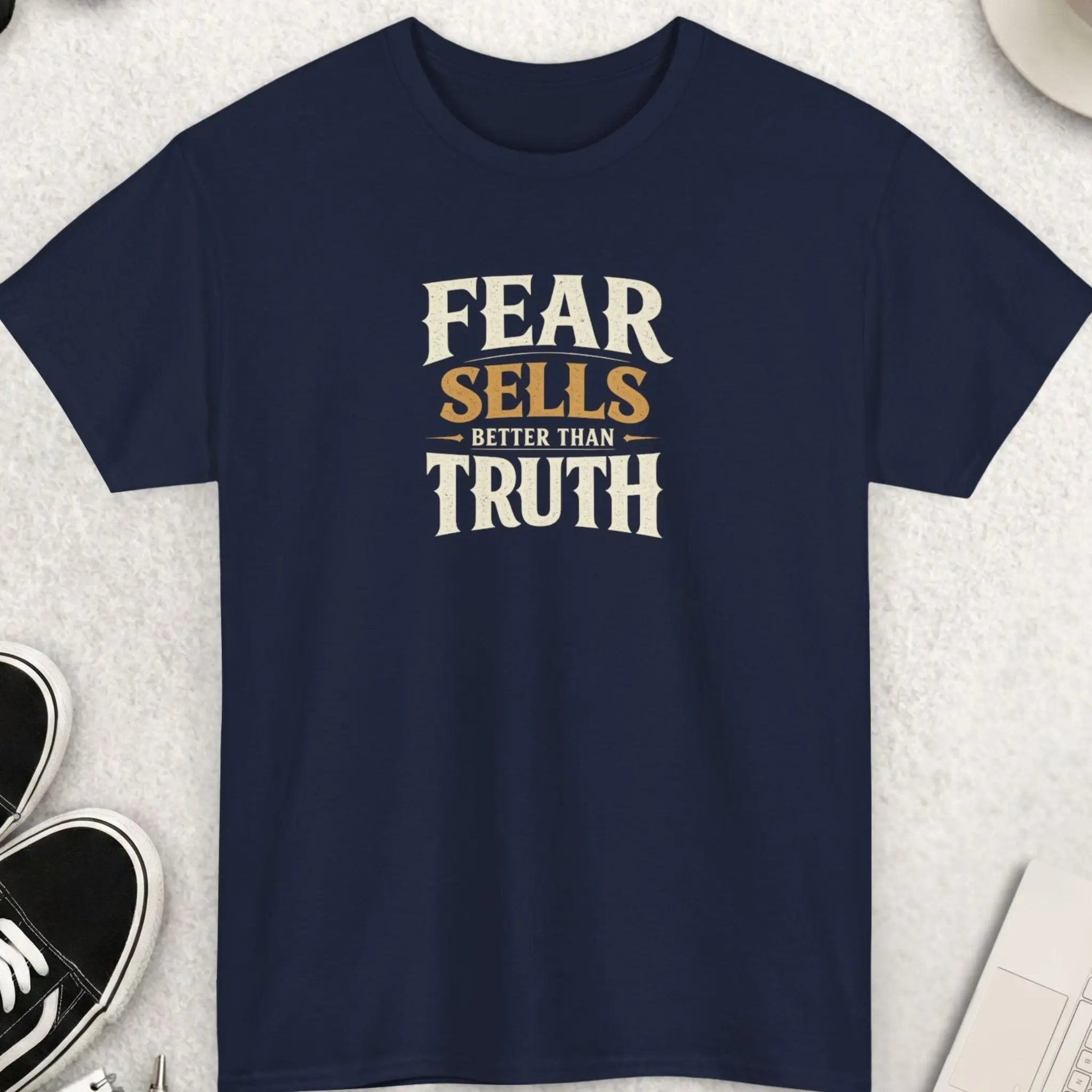 Navy blue t-shirt with distressed typography displaying the phrase “Fear Sells Better Than Truth” in a vintage-inspired worn aesthetic.