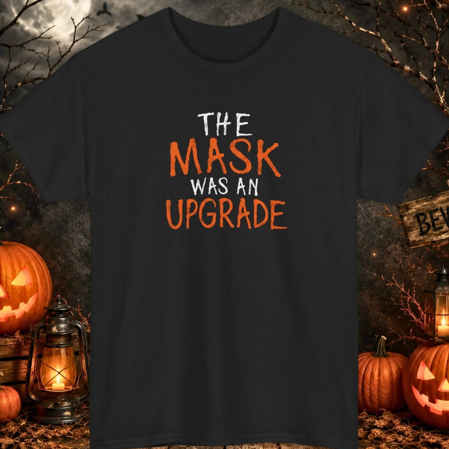 Funny Halloween typography t-shirt featuring the phrase "The Mask Was an Upgrade" in distressed orange and white lettering on a black shirt, perfect for Halloween parties, dark humor lovers, sarcastic personalities, and spooky season apparel.