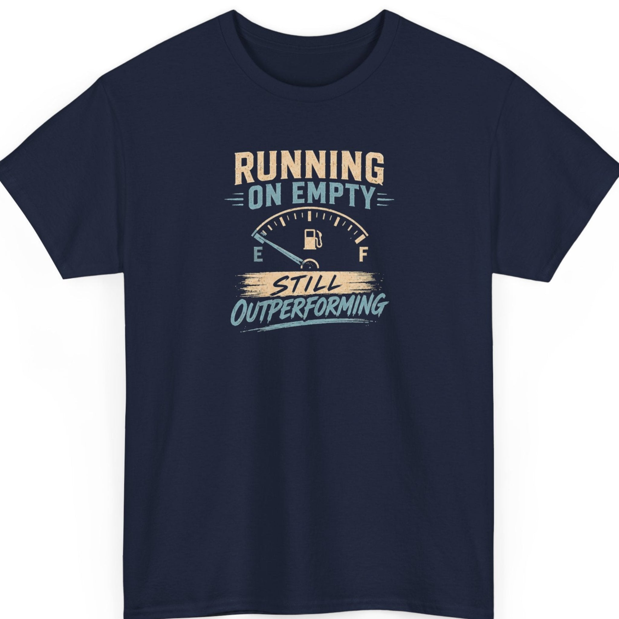 Mayhem Haus burnout humor tee on a navy blue shirt featuring a retro fuel gauge graphic with distressed cream and light blue lettering reading "Running on Empty Still Outperforming."