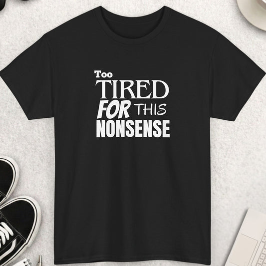 Black t-shirt with 'Too Tired For This Nonsense' text on a light gray surface with accessories.