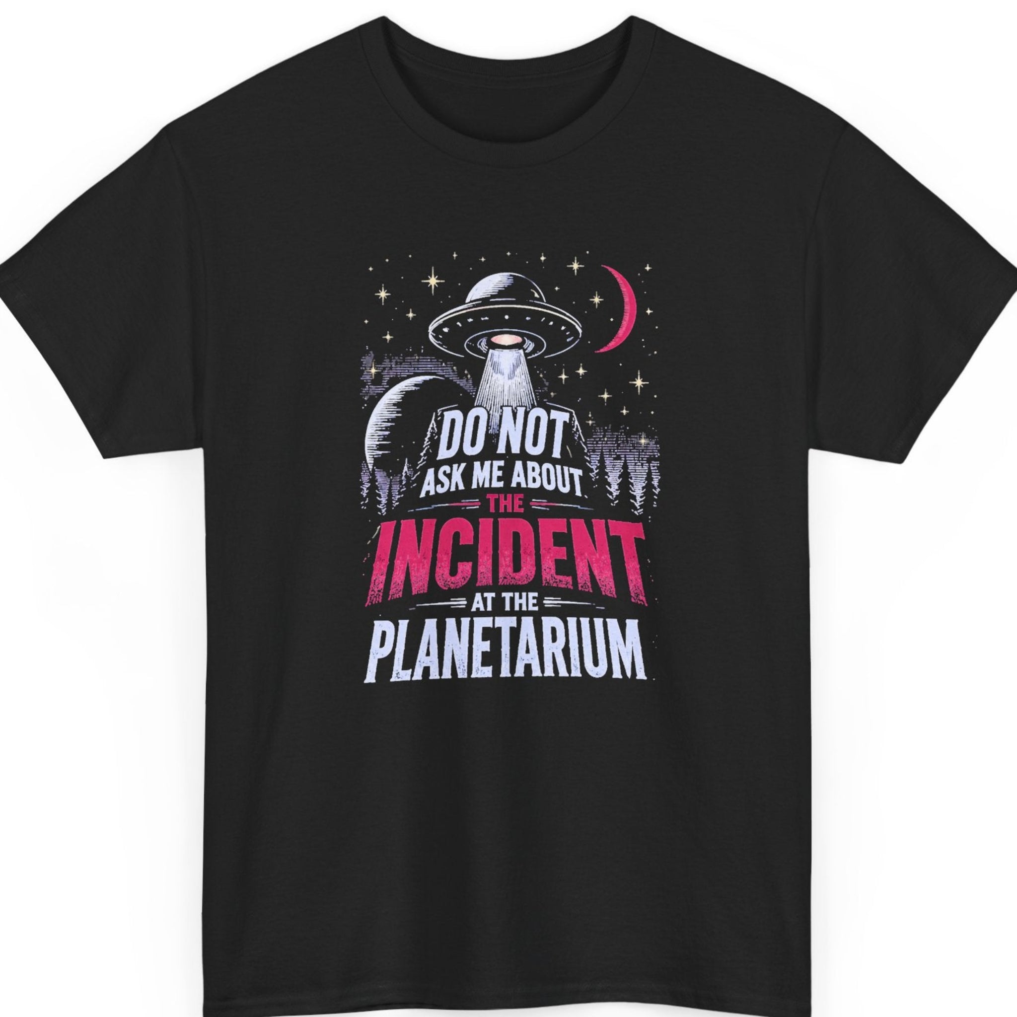 Mayhem Haus surreal humor t-shirt on a black shirt featuring a vintage UFO, alien beam, stars, crescent moon, and forest scene with distressed white, purple, and hot pink typography reading, "Do Not Ask Me About the Incident at the Planetarium."