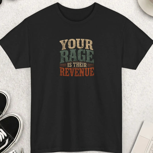 Your Rage Is Their Revenue" vintage distressed typography graphic t-shirt on a black background. Bold stacked lettering in warm cream, sage olive green, and burnt rust orange with a grunge texture finish. Anti-media outrage culture sarcastic statement tee.