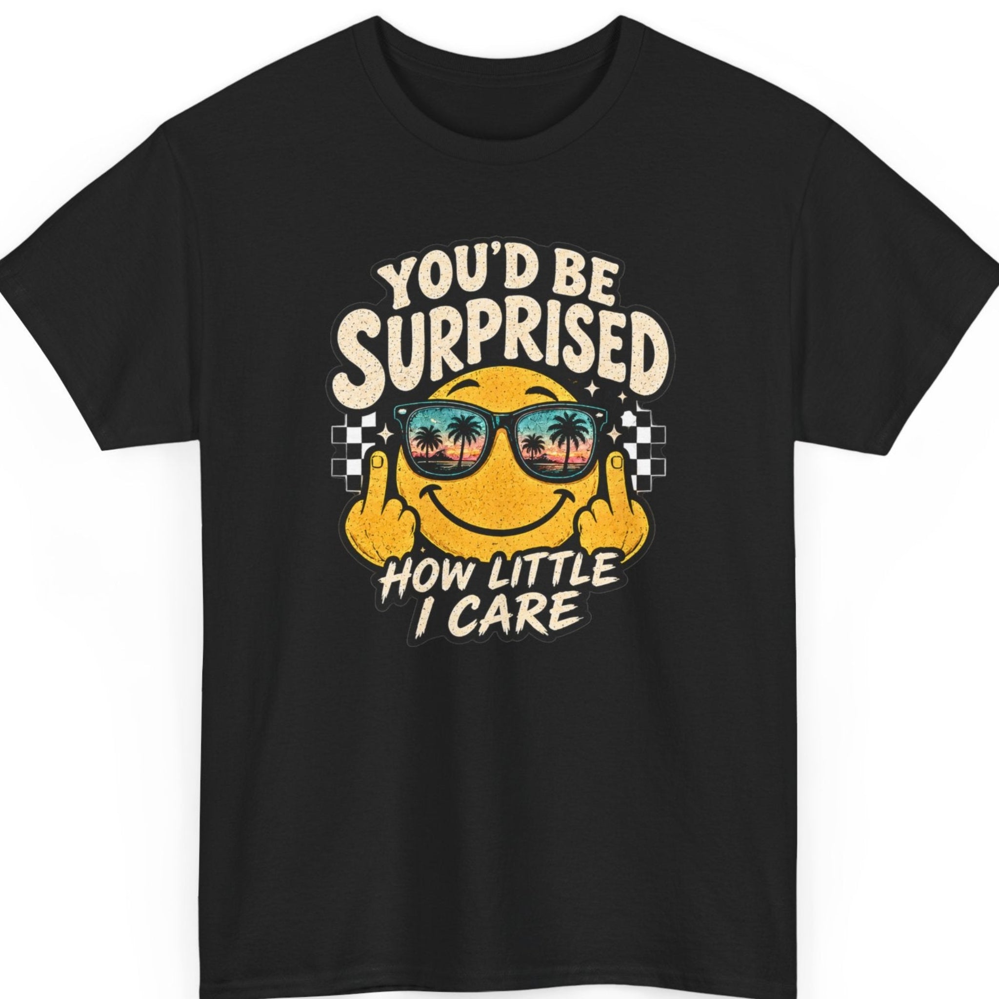 Mayhem Haus “You’d Be Surprised How Little I Care” black t-shirt featuring a retro smiling face wearing sunset sunglasses and raising both middle fingers, with distressed cream typography and checkerboard accents.
