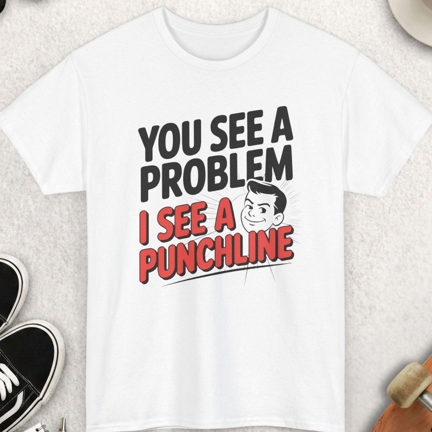 White t-shirt with humorous text design on a light surface with casual items around