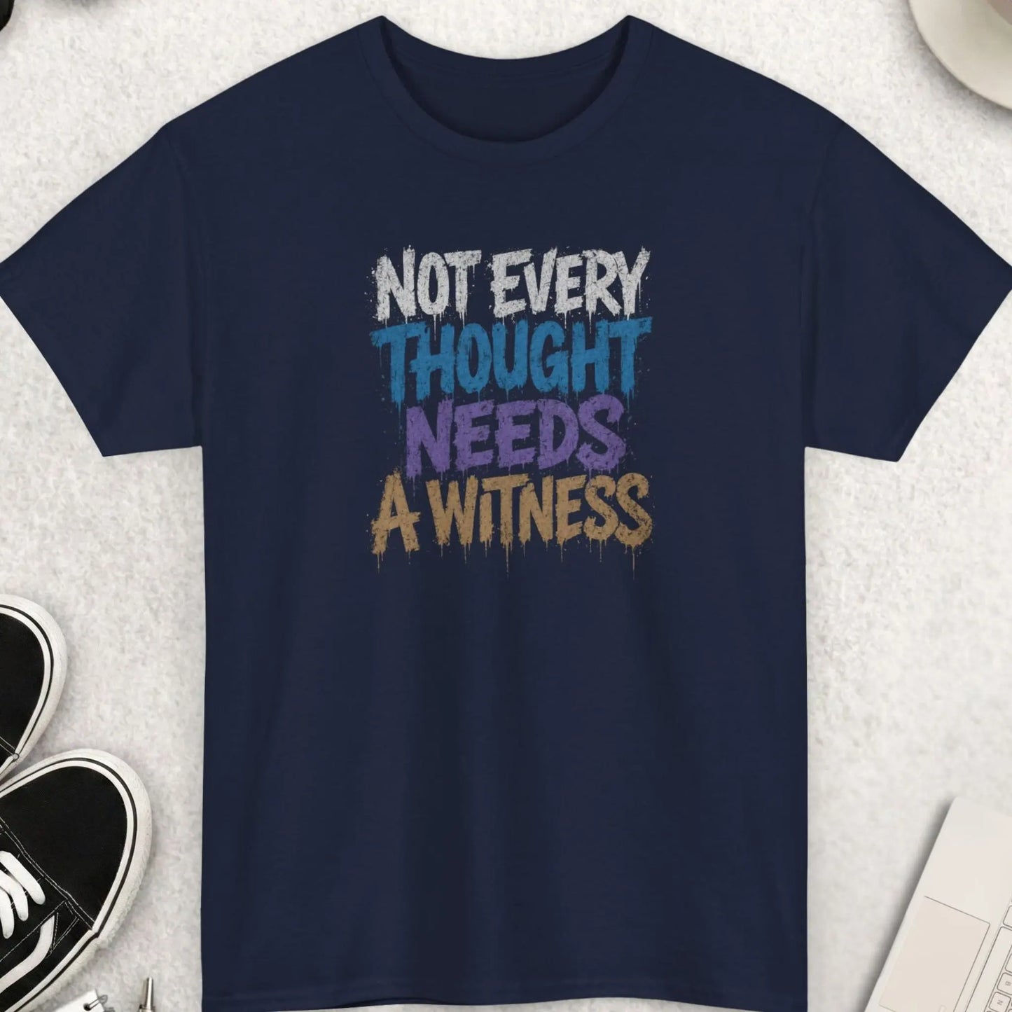 Navy blue sarcastic graphic tee with distressed dripping typography reading “Not Every Thought Needs A Witness” in layered blue, purple, cream, and white street art inspired lettering by Mayhem Haus.