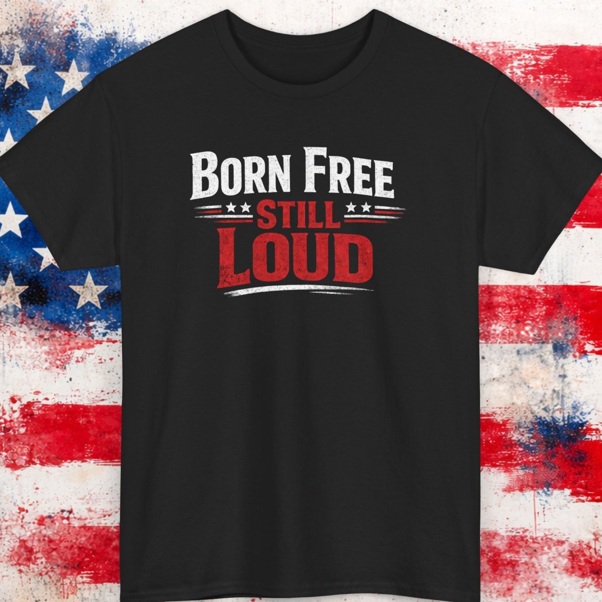 Black t-shirt with 'Born Free Still Loud' text on a background resembling an American flag.