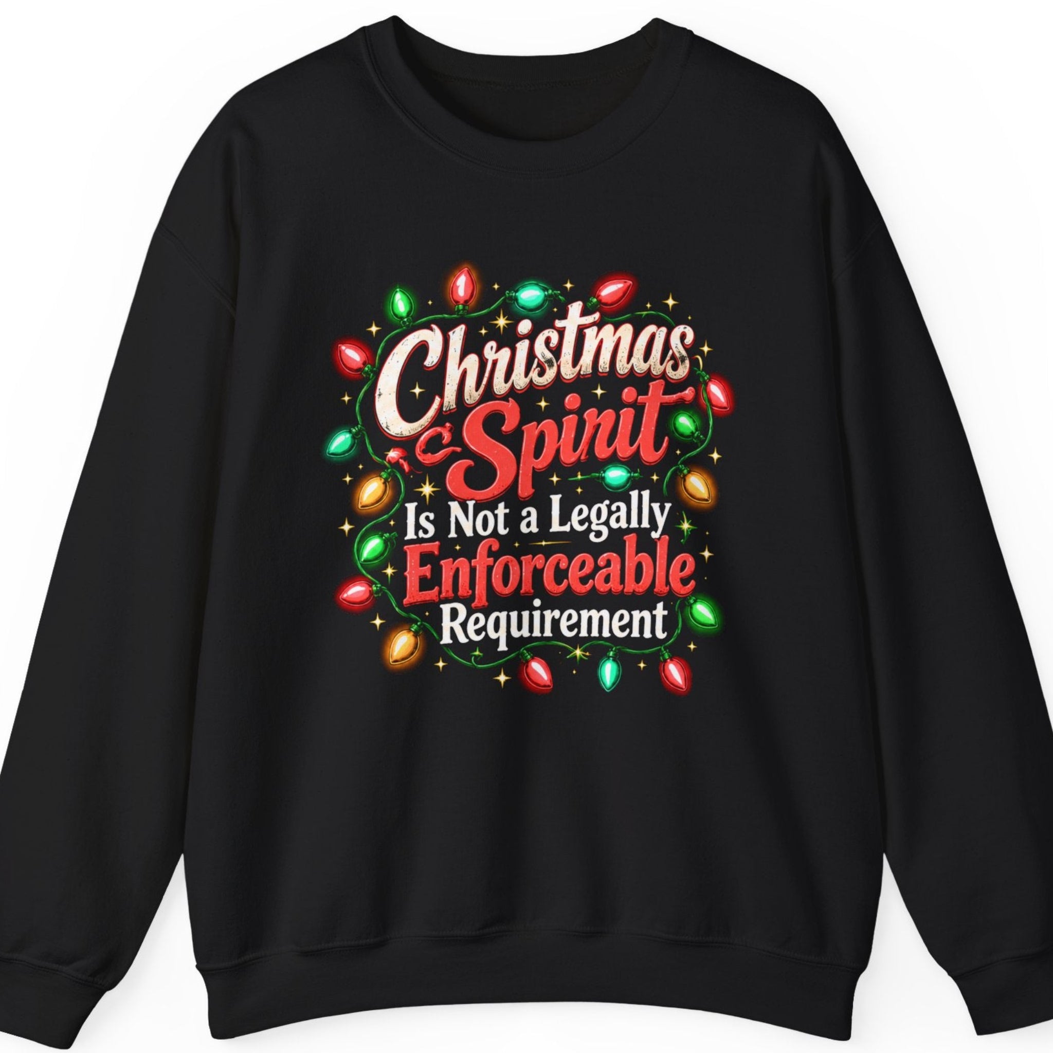 Mayhem Haus “Christmas Spirit Is Not a Legally Enforceable Requirement” black crewneck sweatshirt featuring bold cream-white and red retro Christmas lettering framed by colorful holiday string lights, golden sparkles, and decorative green flourishes in a sarcastic festive design.