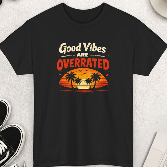 Black t-shirt with 'Good Vibes Are Overrated' graphic on a light gray surface with accessories.