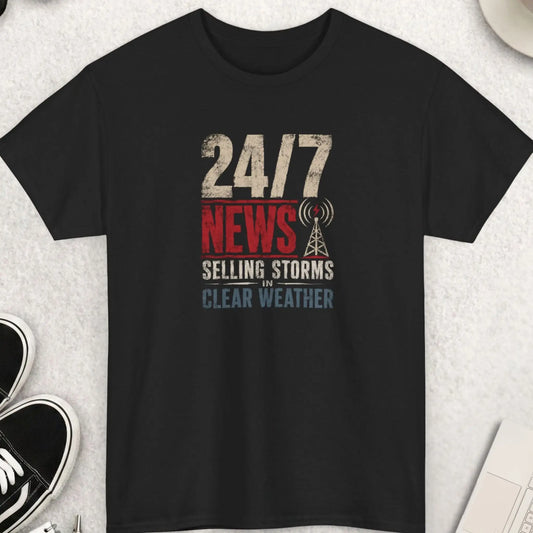 24/7 News Selling Storms In Clear Weather distressed graphic t-shirt featuring bold vintage typography and a broadcast tower graphic on a black shirt. Funny media satire shirt with sarcastic commentary about sensational news coverage and fear-based headlines.