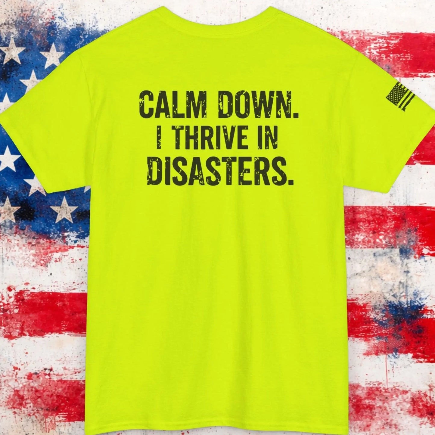 Neon green t-shirt with text 'CALM DOWN. I THRIVEINDISASTERS.' on a distressed American flag background.