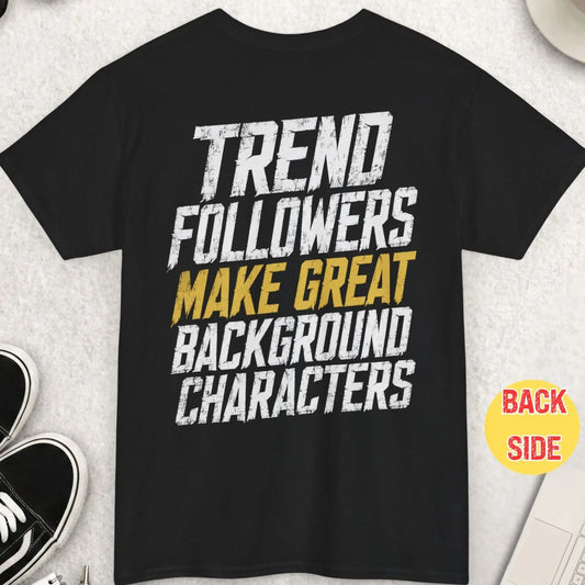 Black distressed graphic t-shirt featuring the phrase “Trend Followers Make Great Background Characters” in oversized white and gold grunge typography with an edgy streetwear aesthetic.