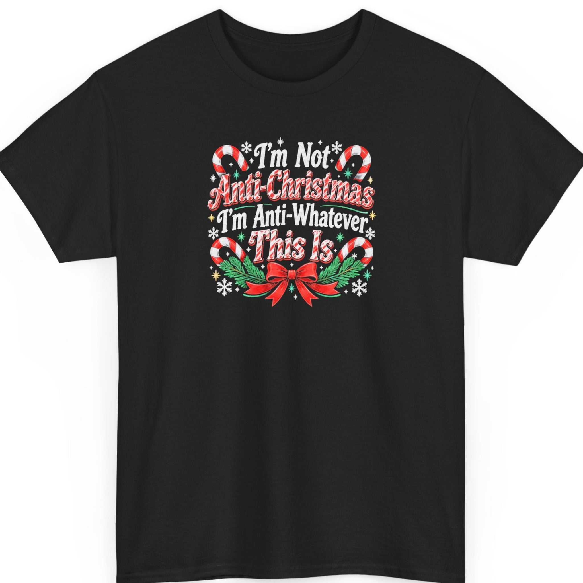 Mayhem Haus “I'm Not Anti-Christmas I'm Anti-Whatever This Is” black t-shirt featuring distressed red and white vintage Christmas typography, surrounded by red-and-white candy canes, green holly leaves, white snowflakes, golden stars, and a decorative red bow with evergreen branches.