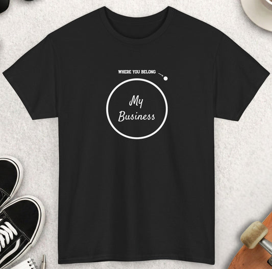Black t-shirt with 'My Business' design on a light gray surface with accessories around.