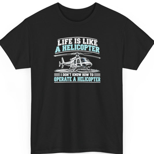 Mayhem Haus “Life Is Like a Helicopter” black t-shirt featuring a detailed white helicopter resting on the ground, surrounded by distressed white and light blue typography reading “Life Is Like a Helicopter I Don't Know How to Operate a Helicopter.”