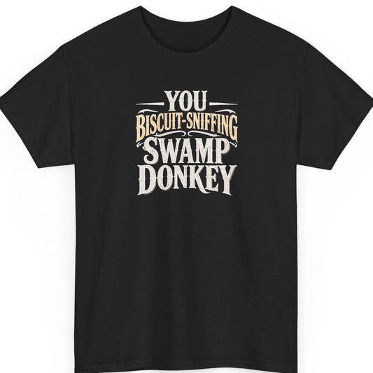 Mayhem Haus “You Biscuit-Sniffing Swamp Donkey” black t-shirt featuring distressed cream and tan Western-style typography in a ridiculous insult design.