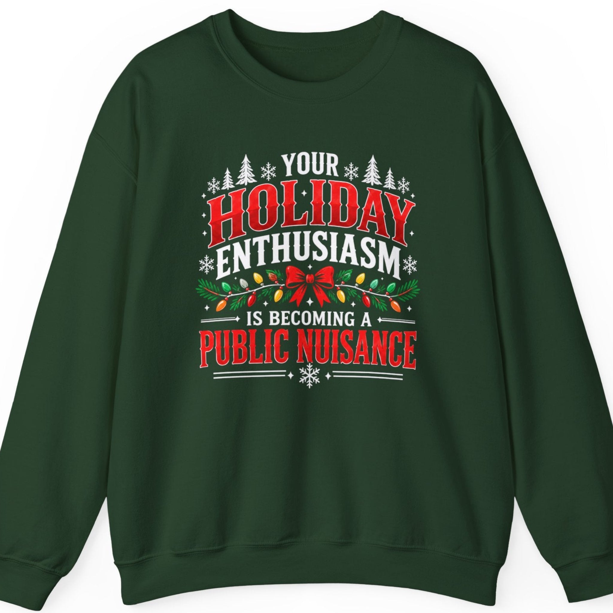 Mayhem Haus “Your Holiday Enthusiasm Is Becoming a Public Nuisance” forest green crewneck sweatshirt featuring bold distressed red and white Christmas typography, decorated with evergreen branches, colorful Christmas lights, a red ribbon bow, white snowflakes, and festive pine trees.