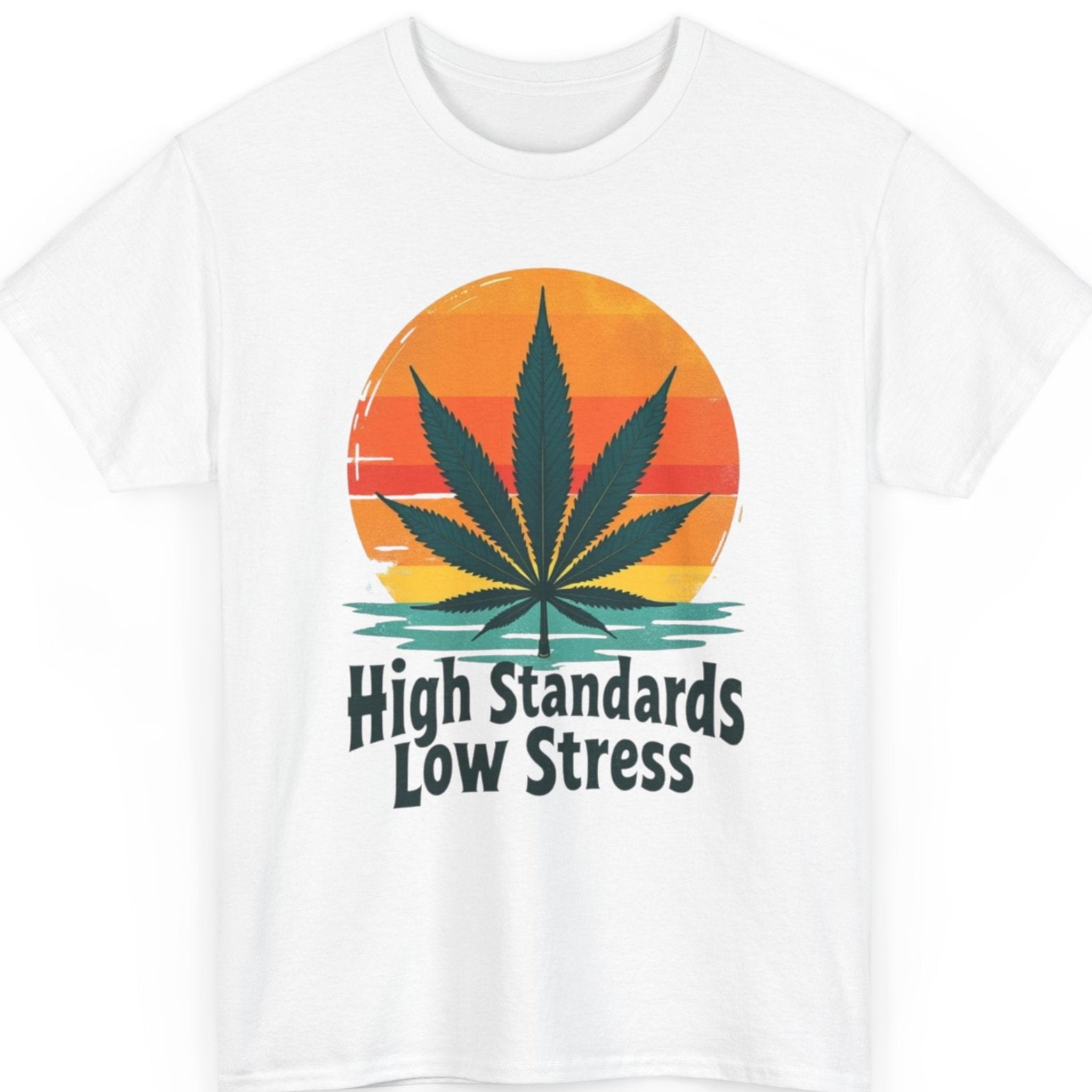 Mayhem Haus retro cannabis t-shirt on a white shirt featuring a colorful sunset, dark green marijuana leaf, and vintage typography that reads "High Standards Low Stress."