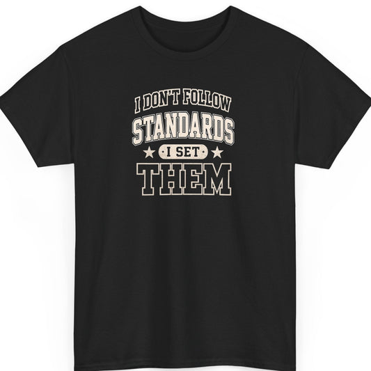 Mayhem Haus varsity typography t-shirt on a black shirt featuring distressed cream lettering reading "I Don't Follow Standards I Set Them" in a bold collegiate design with stars.