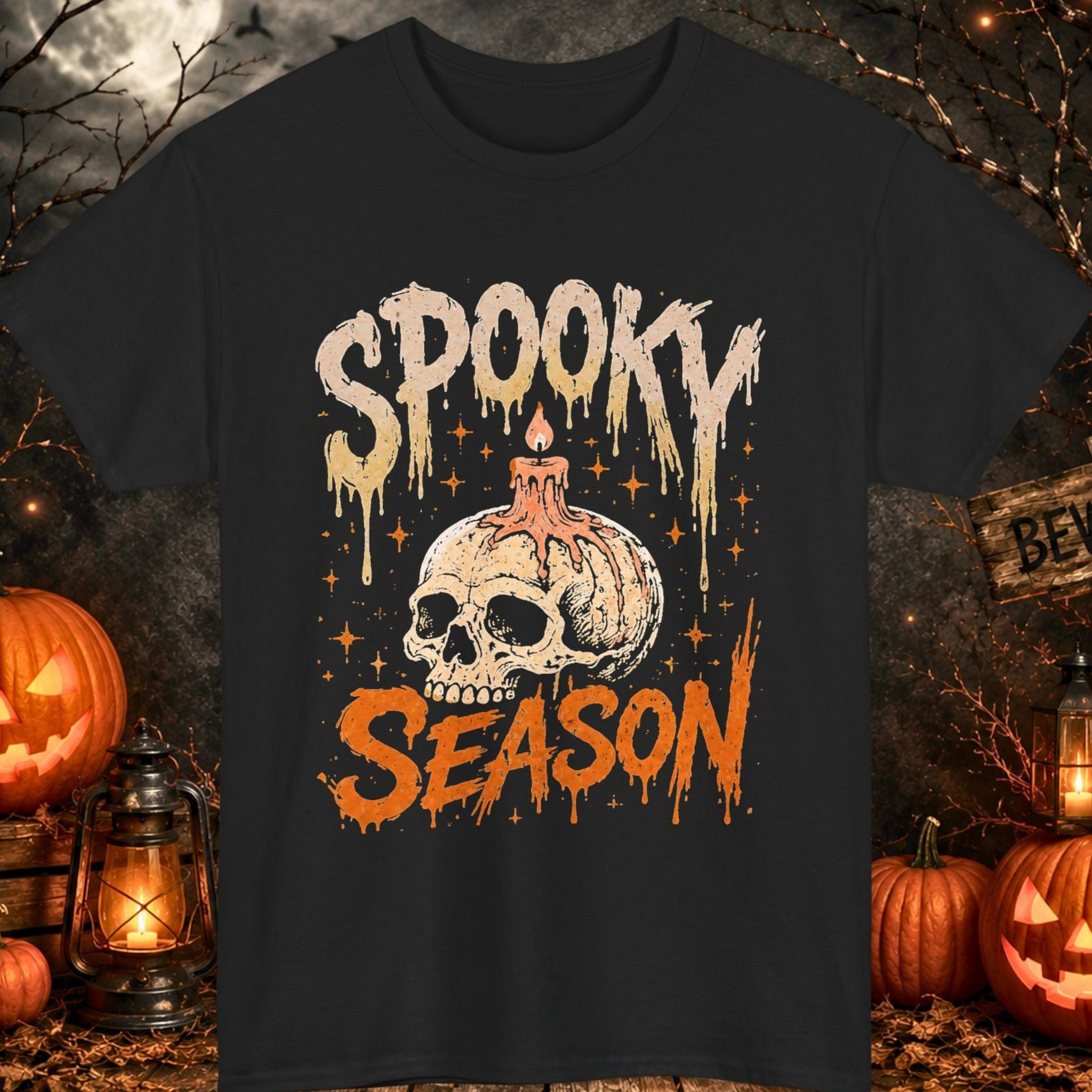 Mayhem Haus black Halloween T-shirt featuring distressed "Spooky Season" typography above a melting skull candle illustration surrounded by vintage orange Halloween artwork. This gothic-inspired graphic tee combines retro horror aesthetics with classic spooky season imagery for Halloween lovers and horror enthusiasts.