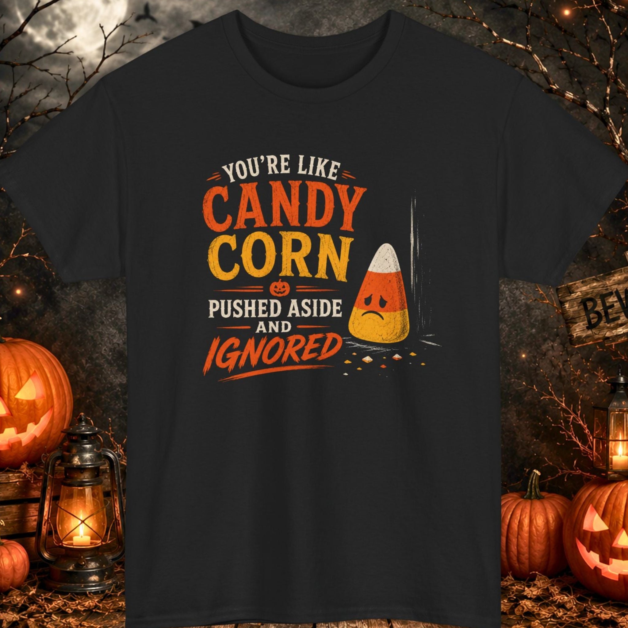 Mayhem Haus funny Halloween graphic t-shirt on a black shirt featuring distressed typography reading "You're Like Candy Corn Pushed Aside and Ignored" beside a sad candy corn illustration with scattered candy pieces in orange, yellow, and cream tones.