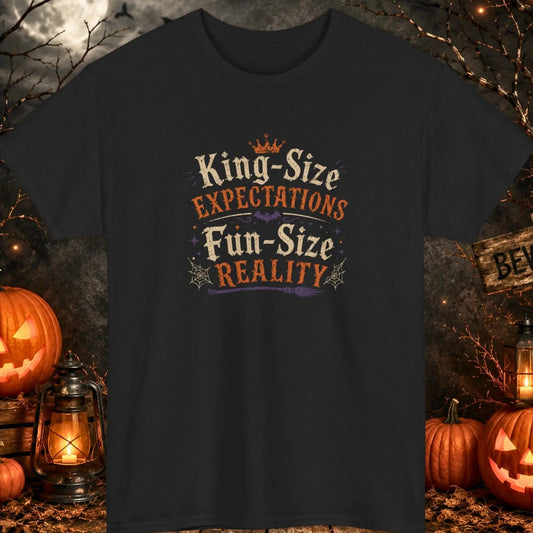 Funny Halloween graphic t-shirt featuring distressed vintage typography reading "King-Size Expectations Fun-Size Reality" with witch-themed accents, bats, spider webs, and spooky Halloween graphics printed on a black shirt, perfect for Halloween parties, candy lovers, and sarcastic humor fans.