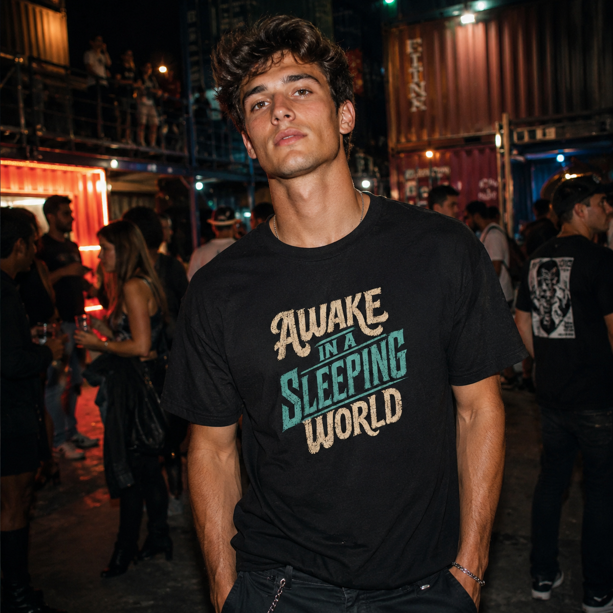 Mayhem Haus Awake in a Sleeping World T-Shirt on a man at a night event