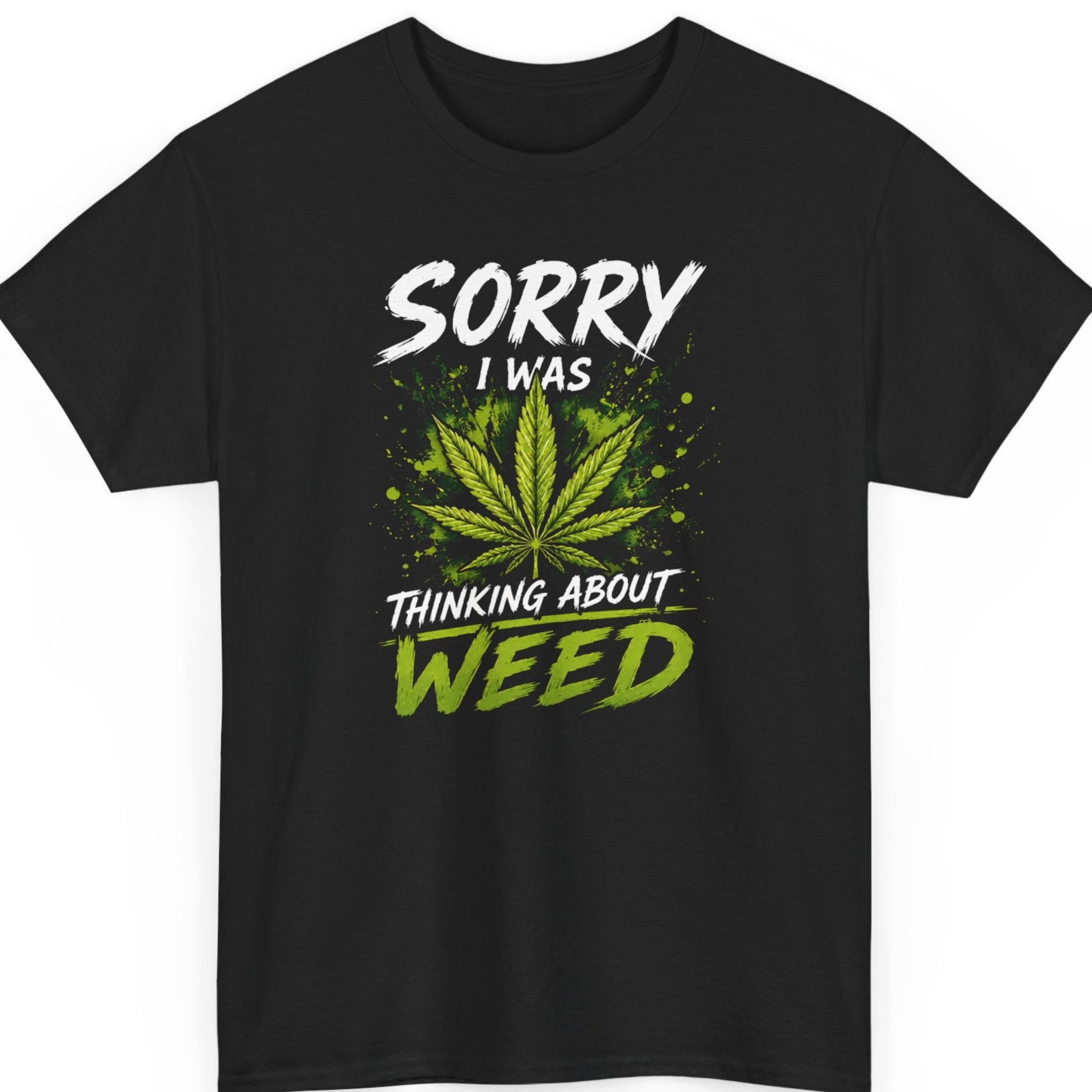 Mayhem Haus funny weed graphic t-shirt on a black shirt featuring a vibrant green marijuana leaf with bold distressed white and green typography reading "Sorry I Was Thinking About Weed."
